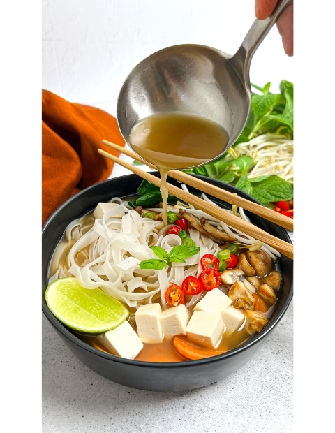 Heartful Flavours Vietnamese Pho Recipe Food Shot Lifestyle with tofu noodles carrot mushroom mint bean sprout lime